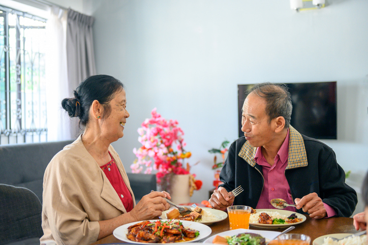 Asian senior couple celebrating chinese new year's eve reunion dinner