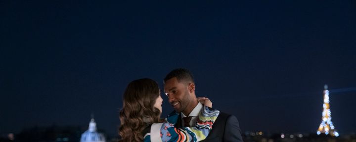 Emily In Paris production stills featuring Lucien Laviscount as Alfie and Lily Collins as Emily kissing