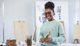 Young female artist is in her painting studio