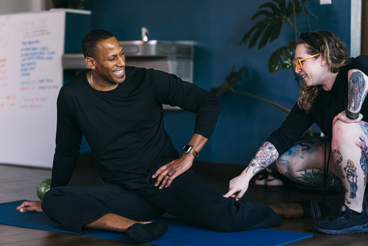 Female personal trainer coaching mature adult client