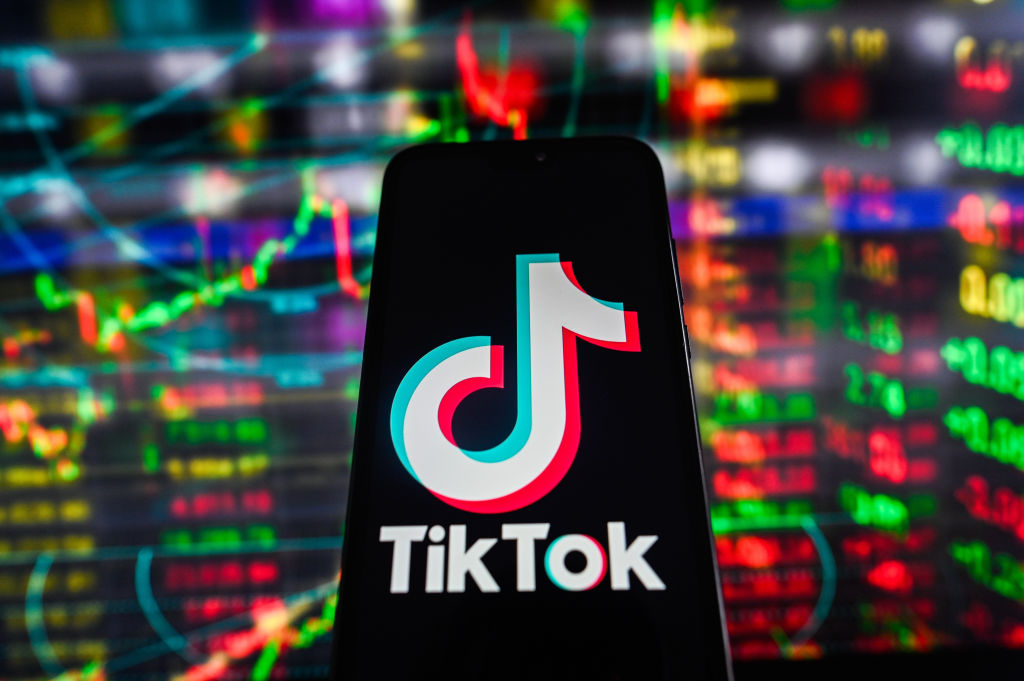 In this photo illustration, a TikTok logo is displayed on a...