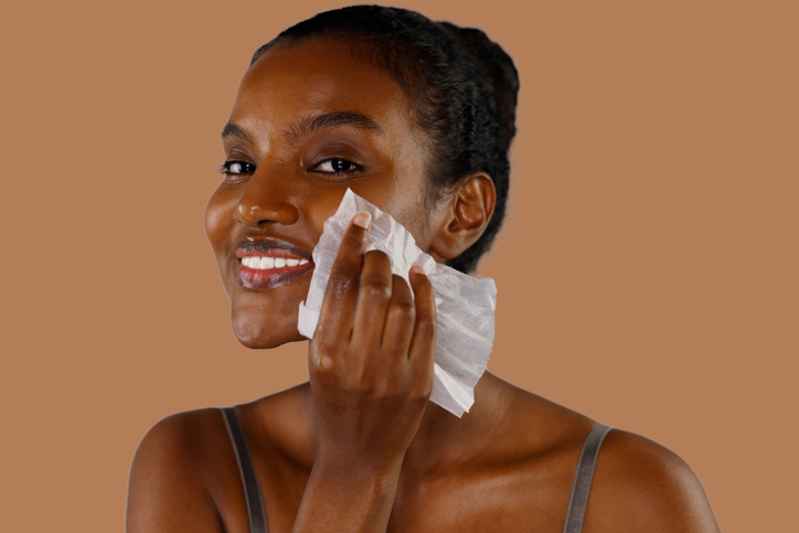 Smiling Black Woman Removing Her Makeup With Wipes