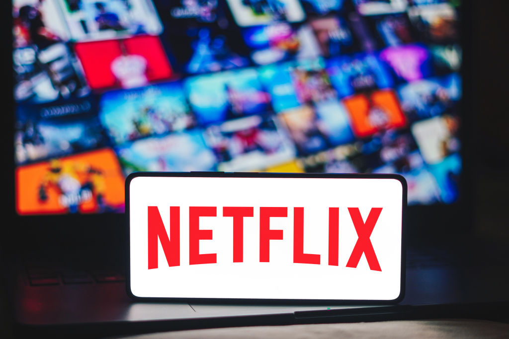 In this photo illustration, the Netflix logo is displayed on...