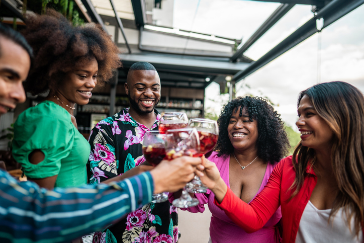 Friends toasting in the restaurant at rooftop