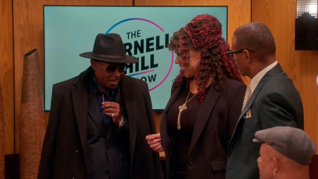 Three people standing in front of a backdrop with "The Varnell Hill Show" logo.