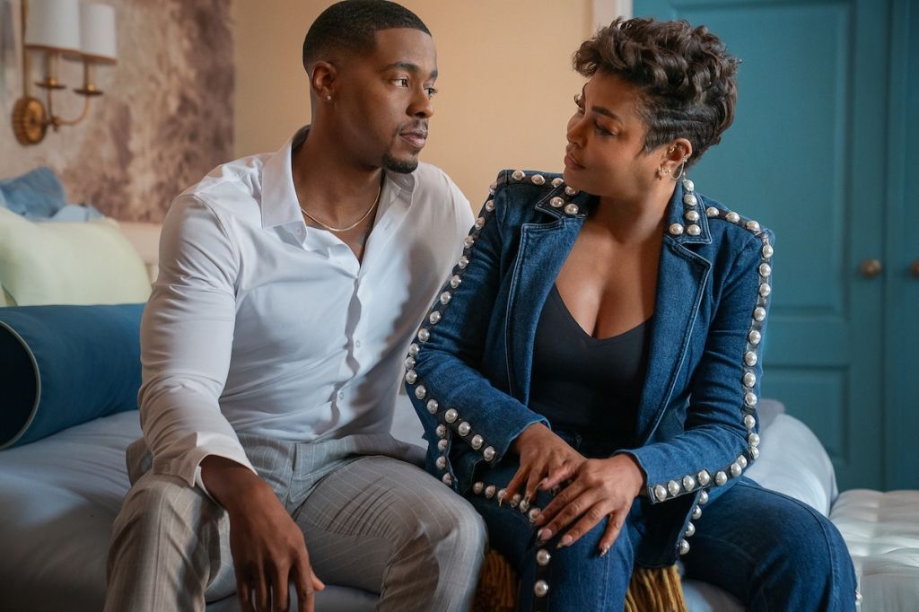 Two people, a man and a woman, sitting on a couch and having a serious conversation.